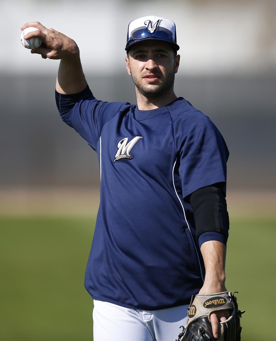 Milwaukee Brewers' Ryan Braun waits to throw the ball as players warm up during spring training baseball practice on Wednesday, Feb. 26, 2014, in Phoenix. (AP Photo/Ross D. Franklin)