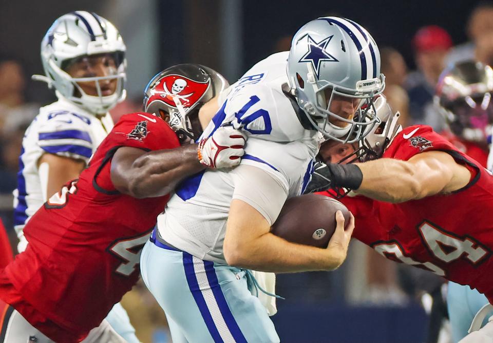 Tampa Bay Buccaneers linebacker Devin White (45) and defensive tackle Willington Previlon (94) sack Dallas Cowboys quarterback Cooper Rush (10) during the second half at AT&T Stadium.