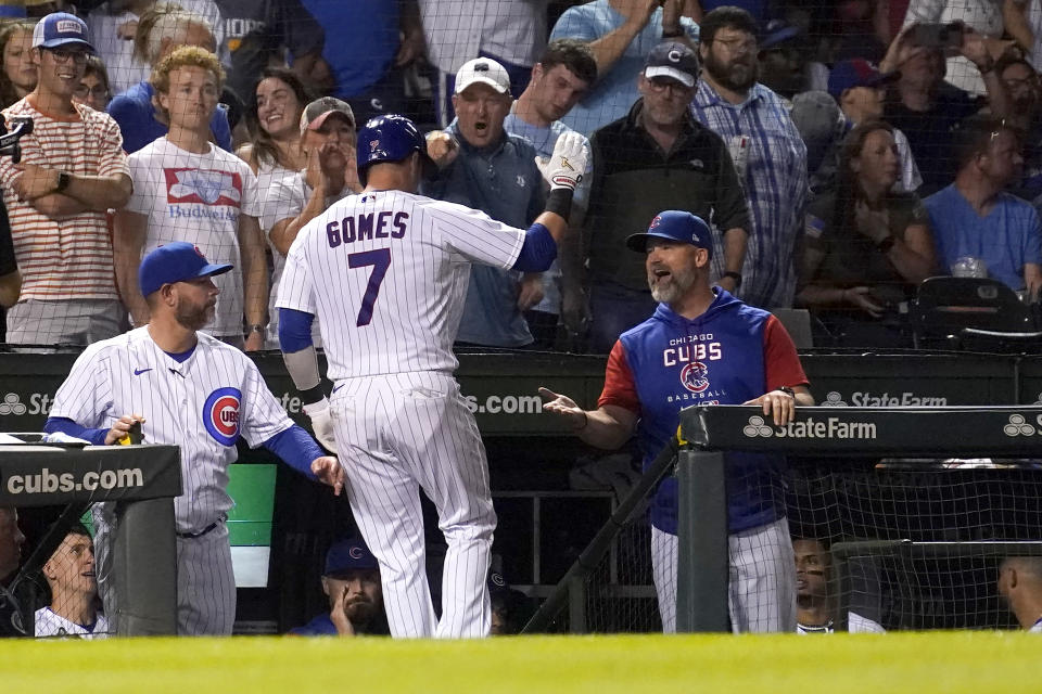 Chicago Cubs' Yan Gomes celebrates his home run off San Diego Padres starting pitcher Yu Darvish with manager David Ross, right, during the second inning of a baseball game Monday, June 13, 2022, in Chicago. (AP Photo/Charles Rex Arbogast)