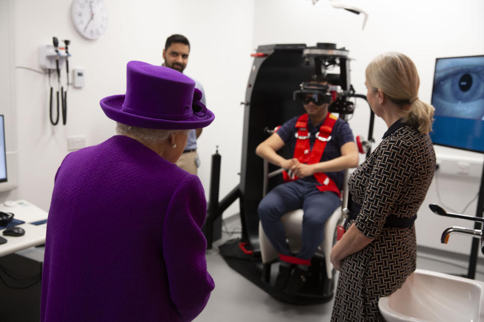 Queen Elizabeth II watching a demonstration with a rotatory chair during the official opening of the new premises of the Royal National ENT and Eastman Dental Hospitals in London.