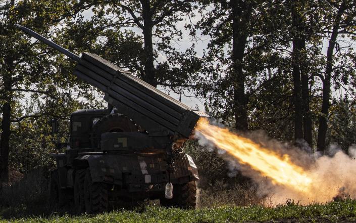 A rocket being fired from the back of a truck.