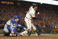 San Francisco Giants' Wilmer Flores, right, is called out swinging in front of Los Angeles Dodgers catcher Will Smith for the final out of the ninth inning of Game 5 of a baseball National League Division Series Thursday, Oct. 14, 2021, in San Francisco. (AP Photo/Jed Jacobsohn)