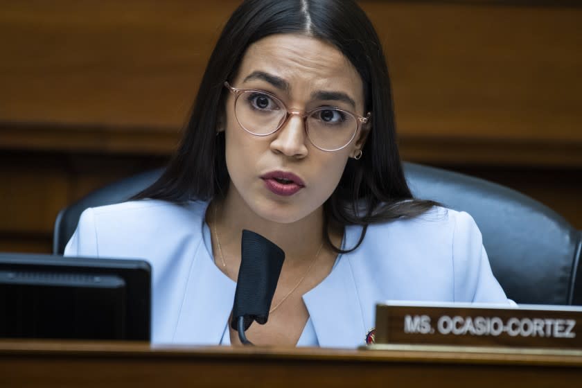 FILE - In this Monday, Aug. 24, 2020, file photo, U.S. Rep. Alexandria Ocasio-Cortez, D-N.Y., questions Postmaster General Louis DeJoy during a House Oversight and Reform Committee hearing on the Postal Service on Capitol Hill, in Washington. On Monday, Feb. 1, 2021, a teary-eyed Ocasio-Cortez recounted hiding in her office bathroom as a man repeatedly yelled "Where is she?" during the insurrection at the U.S. Capitol, and also revealed a sexual assault in her past as she talked about trauma. (Tom Williams/Pool Photo via AP, File)