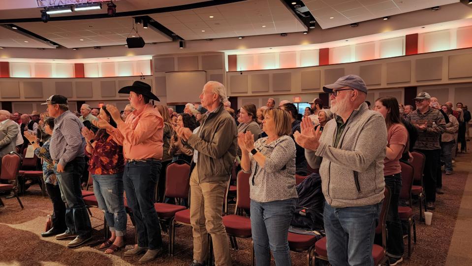 The audience at West Texas A&M's Legacy Hall in the Jack B. Kelley Student Center stand to give Red Steagall a standing ovation during his show.