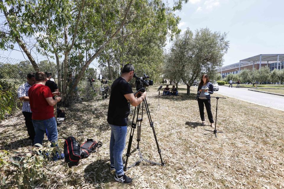 Members of the media report the passing away of Italian composer Ennio Morricone outside the Campus Bio-Medical hospital, on the outskirts of Rome, Monday, July 6, 2020. Oscar-winning Italian composer Morricone, who created the coyote-howl theme for the iconic Spaghetti Western “The Good, the Bad and the Ugly” and often haunting soundtracks for such classic Hollywood gangster movies as “The Untouchables” and the epic “Once Upon A Time In America,” died Monday at the age of 91 following complications after he was hospitalized a month ago due to a femur fracture. (AP Photo/Riccardo De Luca)