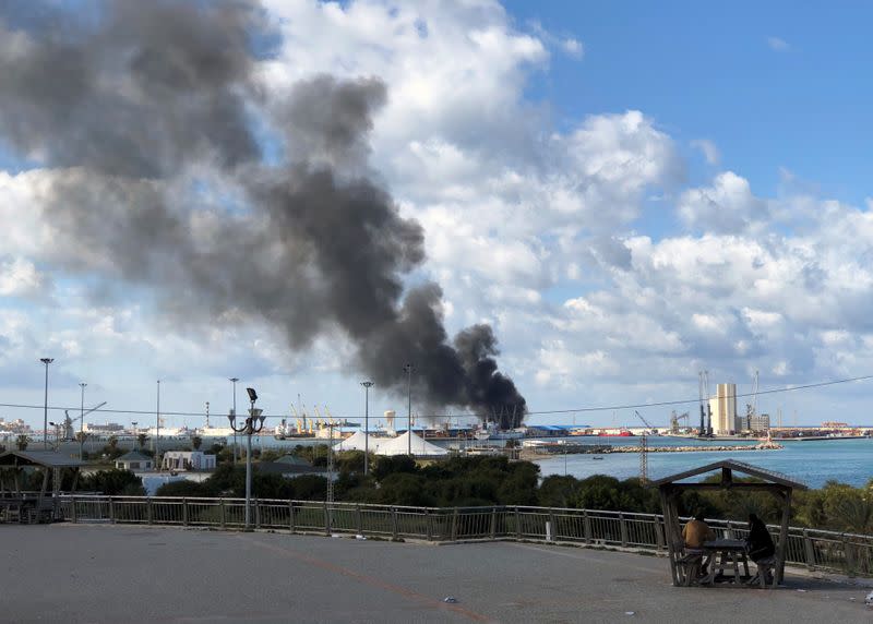 Smoke rises from a port of Tripoli after being attacked in Tripoli