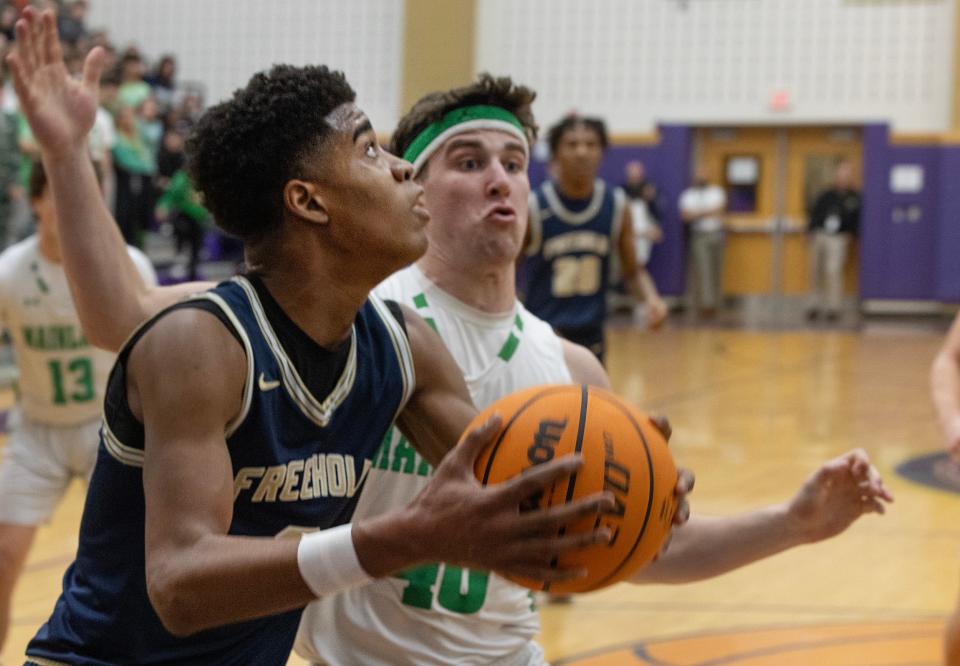 Freehold Borough's Aidan Hamlin-Woolfolk drives against Mainland in the NJSIAA Group 3 Semifinals at Monroe High School on March 6, 2024.
