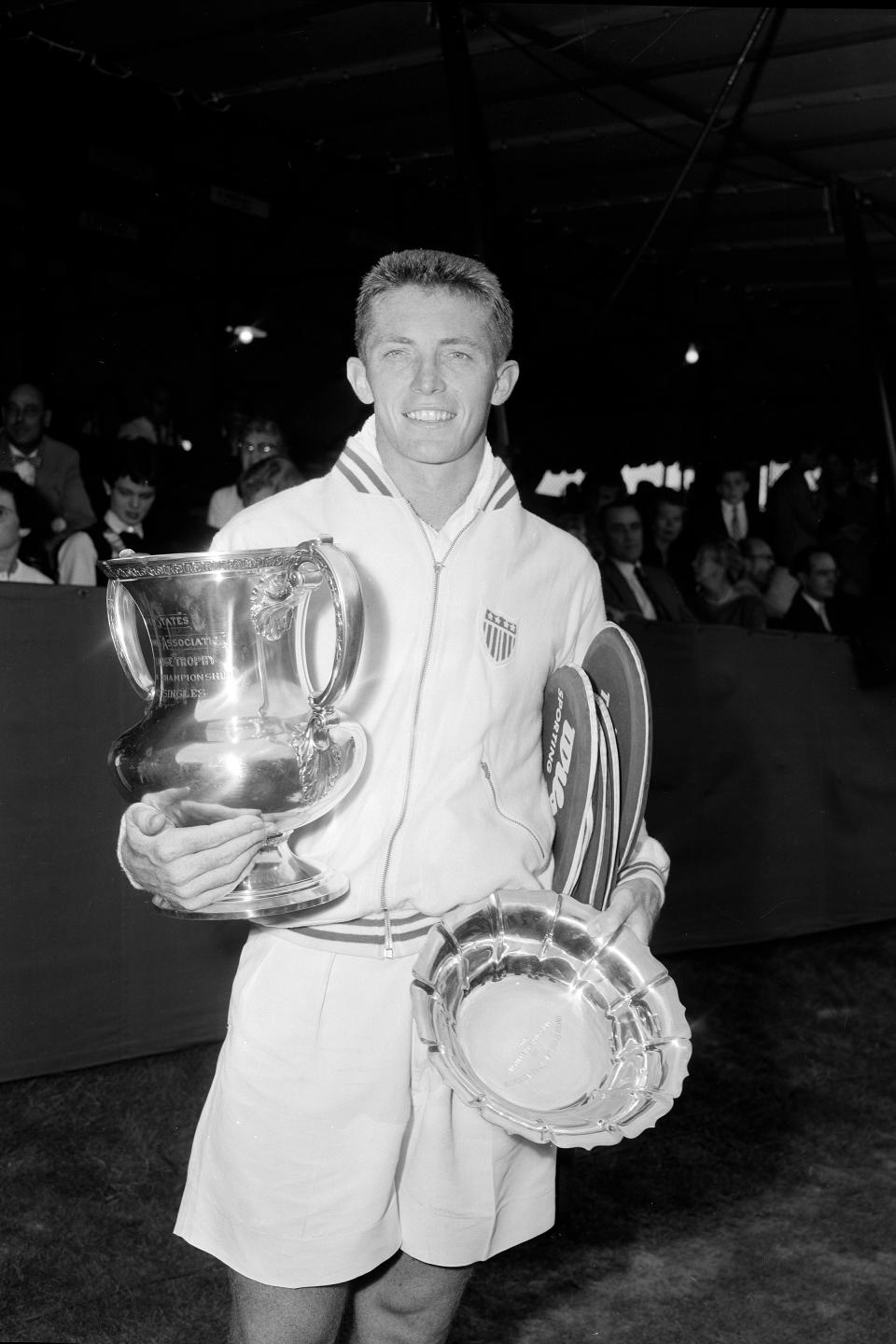 FILE - In this Sept. 1, 1955, file photo, Tony Trabert poses with his trophies at the U.S. Open tennis tournament in Forest Hills, N.Y. Trabert, a five-time Grand Slam singles champion and former No. 1 player who went on to successful careers as a Davis Cup captain, broadcaster and executive, has died. He was 90 years old. The Tennis Hall of Famer's death Wednesday night, Feb. 3, 2021, at his home in Ponte Vedra Beach, Florida, was confirmed by his daughter, Brooke Trabert Dabkowski. (AP Photo/Anthony Camerano, FIle)