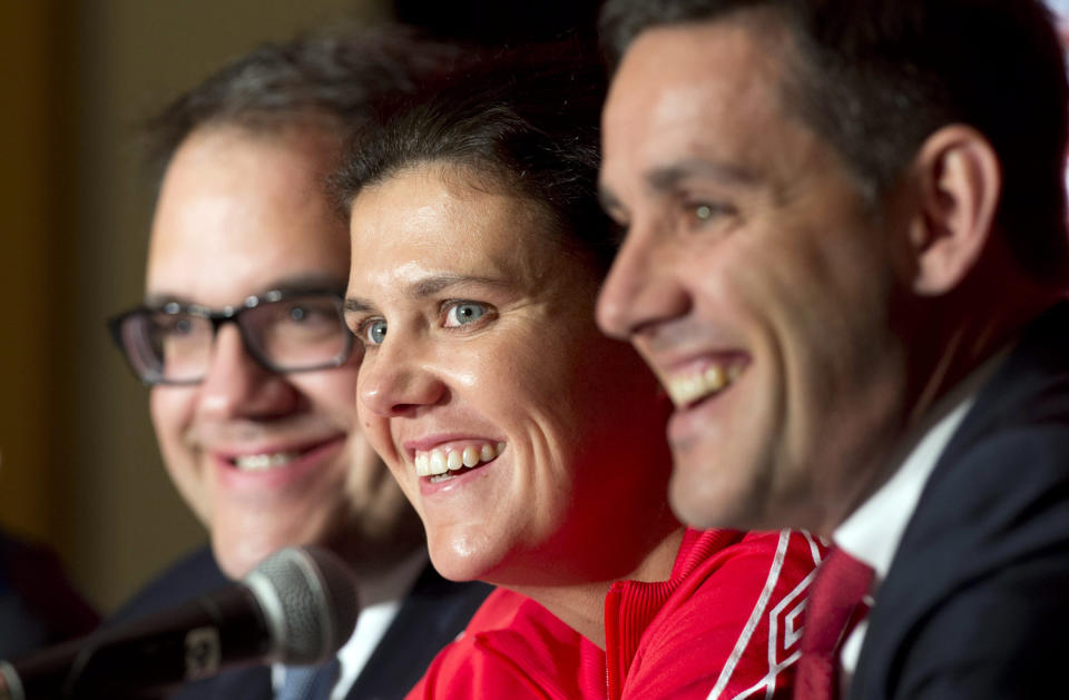 Canadian national women's team captain Christine Sinclair laughs with coach John Herdman (right) and World Cup organizing committee member Victor Montagliani during a FIFA Women's World Cup soccer news conference Friday. {The Canadian Press, Adrian Wyld)