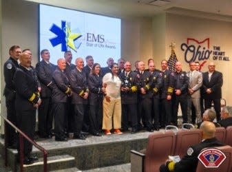 Jackson Township police and firefighter/paramedics received the 2024 EMS Star of Life Award for their life-saving actions after Jonetta Ross, front, center, was seriously injured in a SARTA bus crash on Sept. 25. The Ohio Department of Public Safety’s Division of EMS presented the awards Wednesday in Columbus.