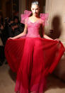 <b>Alexis Mabille Haute Couture SS13</b> <br><br>Backstage models with silver locks showed off chiffon, pleated designs with oversized bow shoulders.<br><br>© Rex