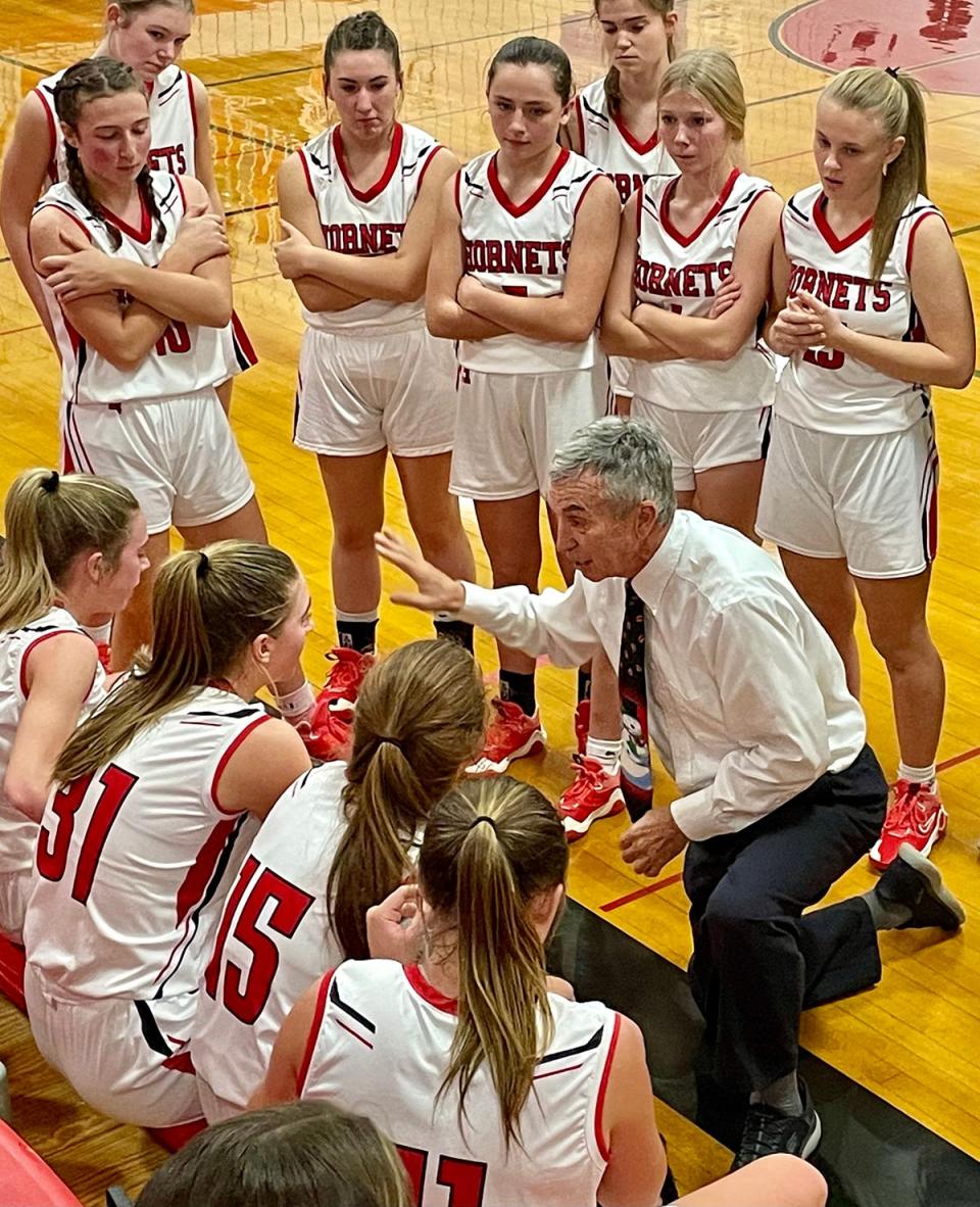 Honesdale girls varsity basketball coach Ron Rowe exhorts his squad during a timeout.