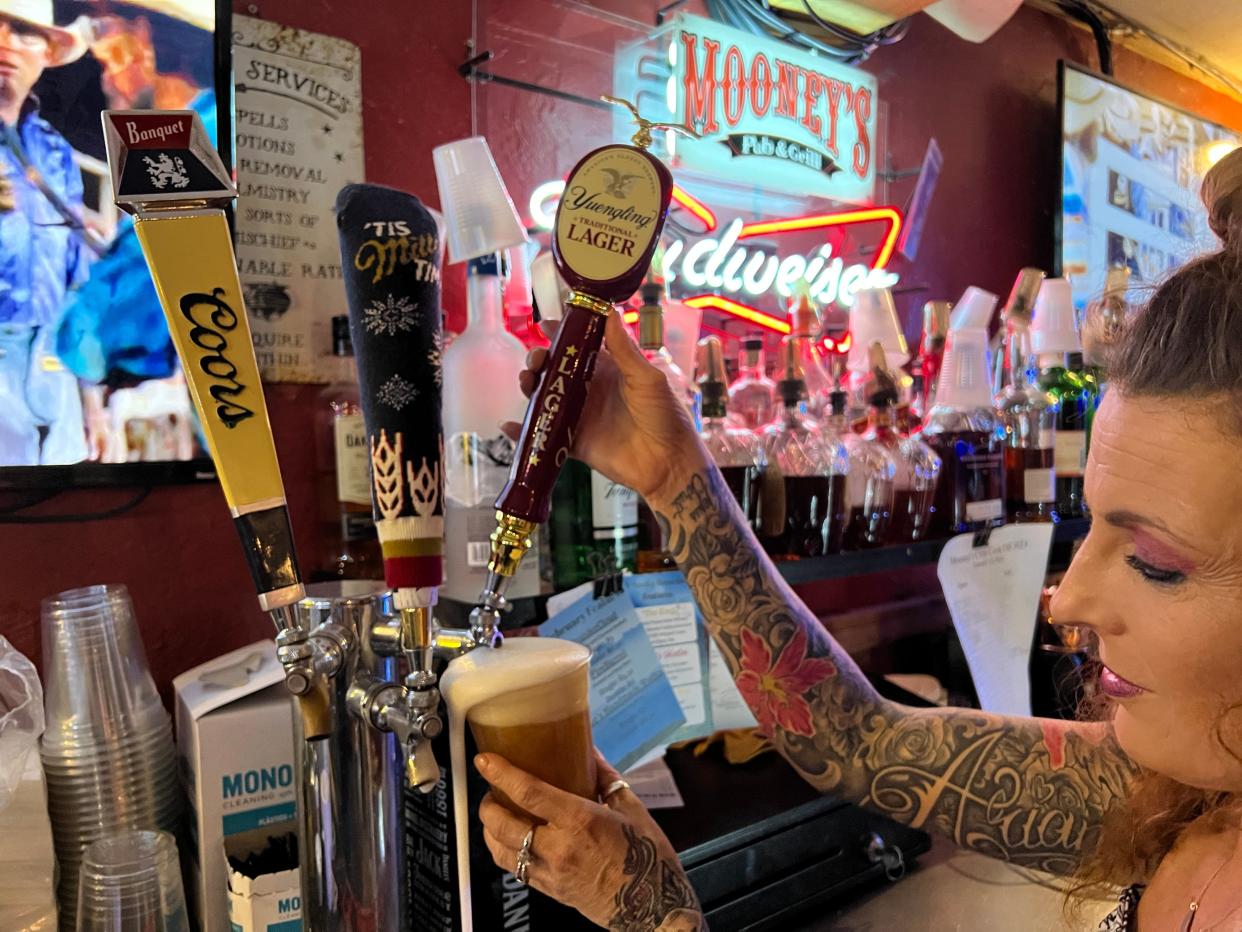 Amber VanCuren pours a Yuengling beer at Mooney's Pub & Grill in Norman on the first day the lager was available to customers in bars in Oklahoma, Feb. 6.