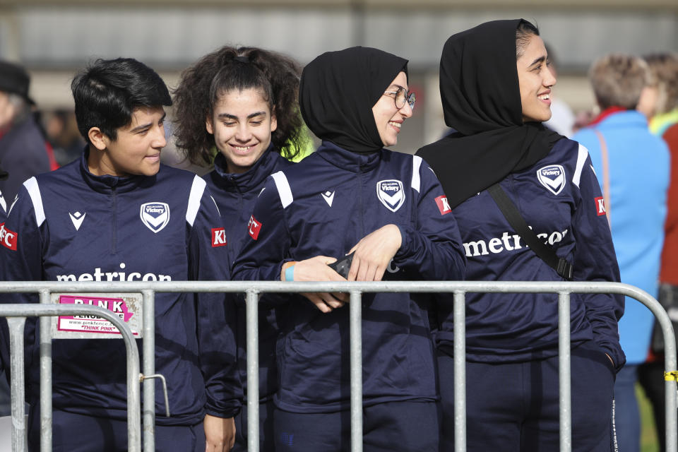 Members of the Afghan women's football team attend Morocco's practice ahead of the Women's World Cup in Melbourne, Australia, Wednesday, July 19, 2023. Some of the team left Afghanistan after the Taliban retook power in 2021 and came out to support the Moroccan women and show that Muslim women belong in sports. (AP Photo/Victoria Adkins)