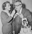 <p>The actress feeds her fourth and final husband, Pepsi CEO Alfred Steele, some cake following their nuptials at the Flamingo Hotel.</p>
