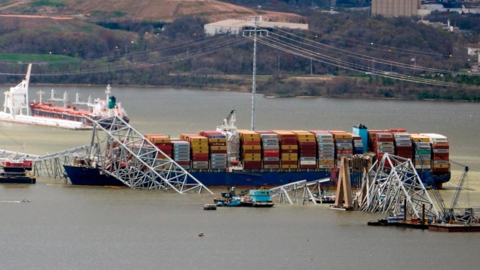 PHOTO: Wreckage of the Francis Scott Key Bridge rests on the container ship Dali, as President Joe Biden takes an aerial tour of the collapsed Francis Scott Key Bridge in Baltimore, April 5, 2024, as seen from an accompanying aircraft.  (Manuel Balce Ceneta/AP)