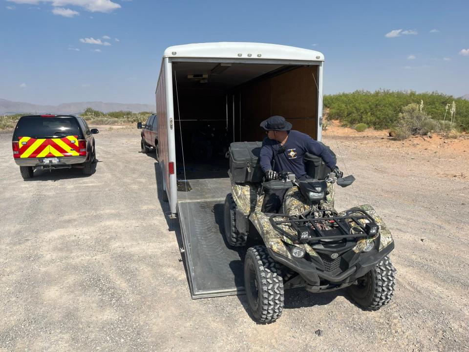 Sunland Park Fire Department rescue crews ride all-terrain vehicles to reach a body found in the desert off Highway 9 on Saturday near Santa Teresa, New Mexico.