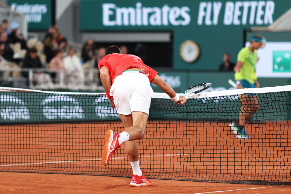Novak Djokovic (pictured) hits the net at Rolland Garros. 