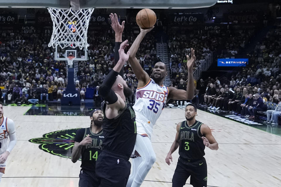 Phoenix Suns forward Kevin Durant (35) shoots against New Orleans Pelicans center Jonas Valanciunas during the first half of an NBA basketball game in New Orleans, Friday, Jan. 19, 2024. (AP Photo/Gerald Herbert)