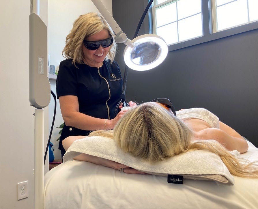 Kelly Wert, a cosmetic therapist and co-owner of The Laser Loft, does laser hair removal on Rebecca Conley on Tuesday, Aug. 22. Wert, who has lived in Newark for 23 years, opened The Laser Loft in Gahanna with Dr. Bill Luft 18 years ago.