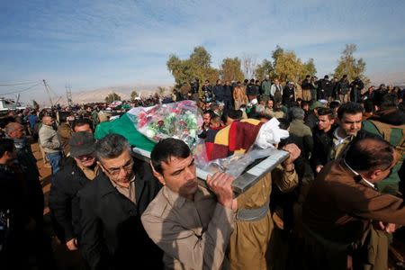 Mourners carry the bodies of the victims who were killed in a bomb attack at the offices of the Democratic Party of Iranian Kurdistan (PDKI) in Koy Sanjak, east of Erbil, Iraq, December 21, 2016. REUTERS/Azad Lashkari