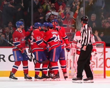 Nov 27, 2018; Montreal, Quebec, CAN; Montreal Canadiens center Phillip Danault (24) celebrates his goal against Carolina Hurricanes goaltender Curtis McElhinney (35) with teammates during the third period at Bell Centre. Mandatory Credit: Jean-Yves Ahern-USA TODAY Sports