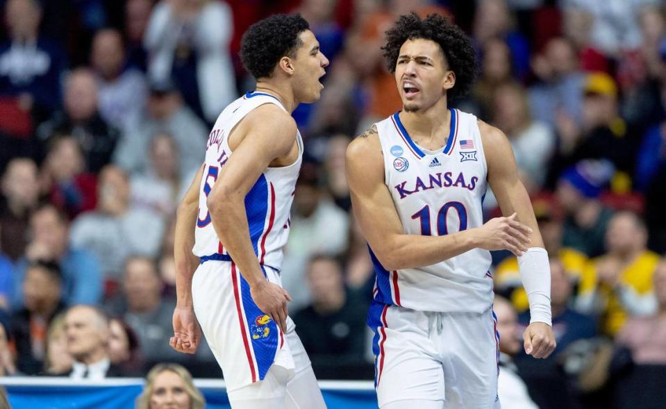 Kansas forward Jalen Wilson (10) celebrates with guard Kevin McCullar Jr. (15) after drawing a foul while scoring against Arkansas during a second-round college basketball game in the NCAA Tournament Saturday, March 18, 2023, in Des Moines, Iowa.