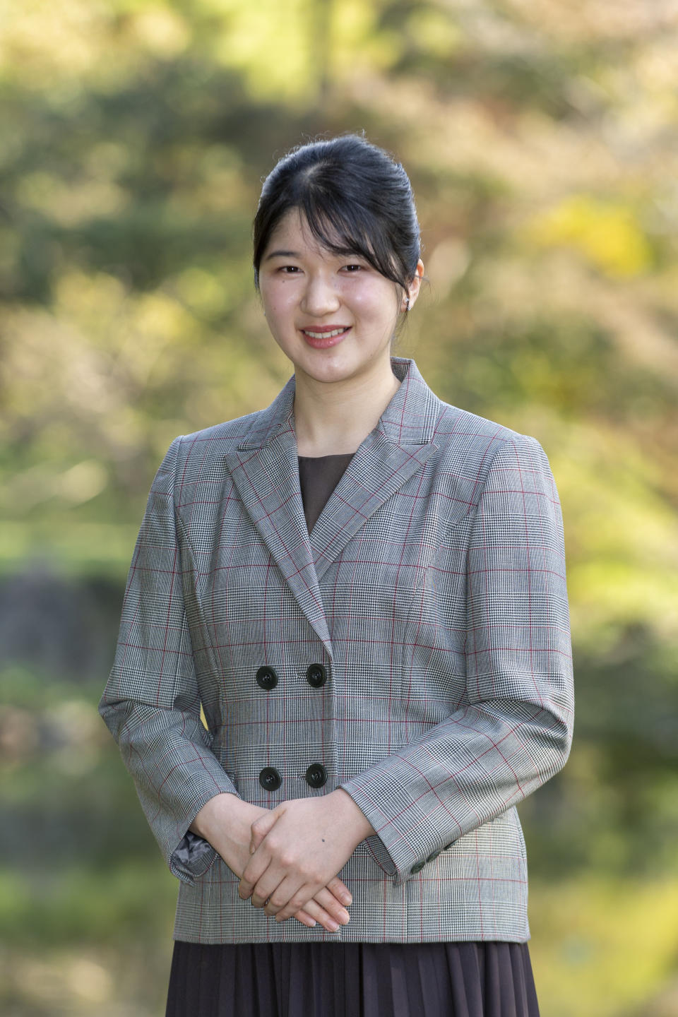 In this photo provided by the Imperial Household Agency of Japan, Princess Aiko, daughter of Emperor Naruhito and Empress Masako, strolls in the garden of the Imperial Residence at the Imperial Palace in Tokyo on Nov. 14, 2021, ahead of her 20th birthday on Dec. 1, 2021. (The Imperial Household Agency of Japan via AP)