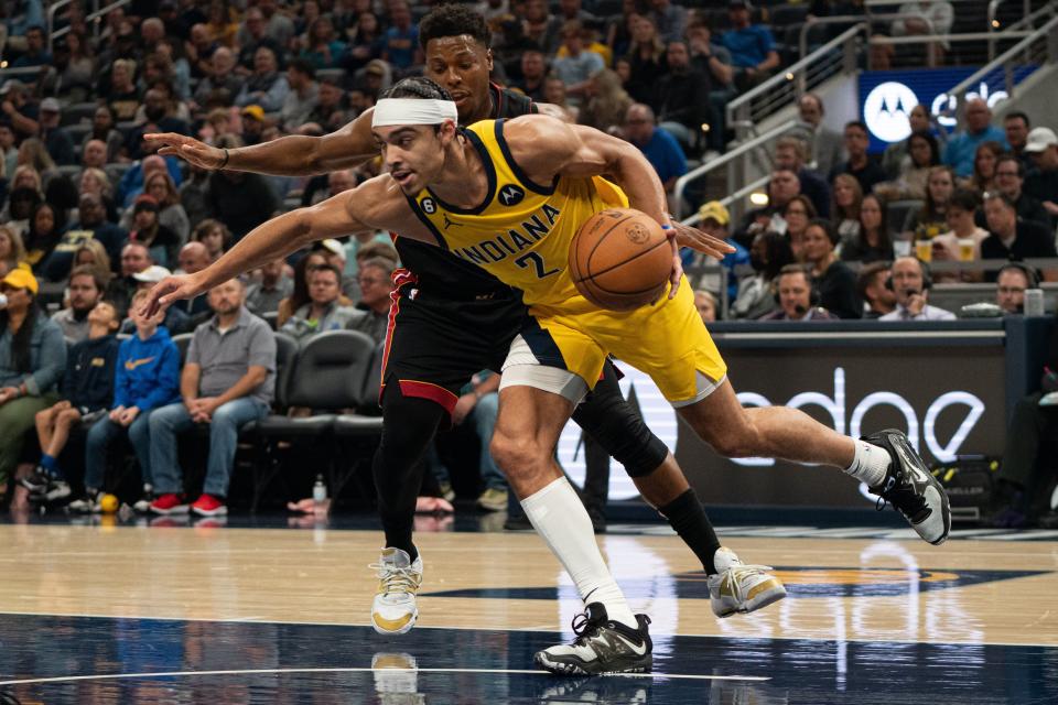 Nov 4, 2022; Indianapolis, Indiana, USA; Indiana Pacers guard Andrew Nembhard (2) secures a rebound against Miami Heat guard Kyle Lowry (7) during the first half at Gainbridge Fieldhouse
