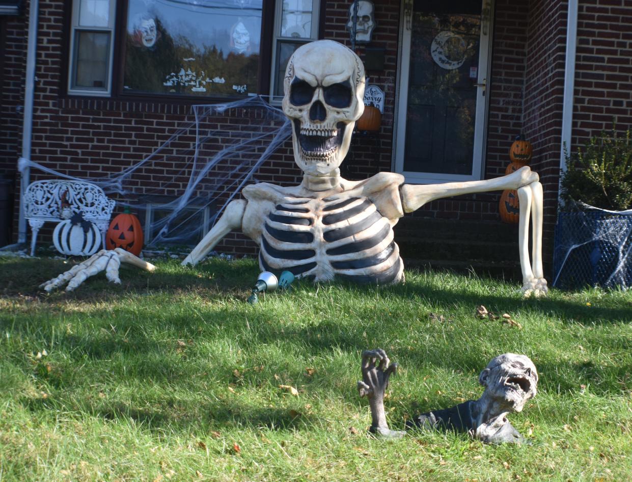 Skeletons big and small pop through the lawn of a Connecticut Avenue home in Cherry Hill.