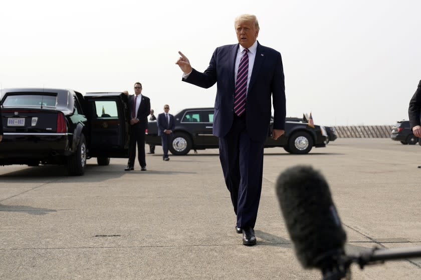 President Donald Trump walks to speak to reporters as he arrives at Sacramento McClellan Airport