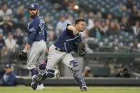 Tampa Bay Rays catcher Francisco Mejia throws out Seattle Mariners' Luis Torrens at first on a grounder as pitcher Andrew Kittredge, left, watches during the fifth inning of a baseball game Friday, June 18, 2021, in Seattle. (AP Photo/Ted S. Warren)