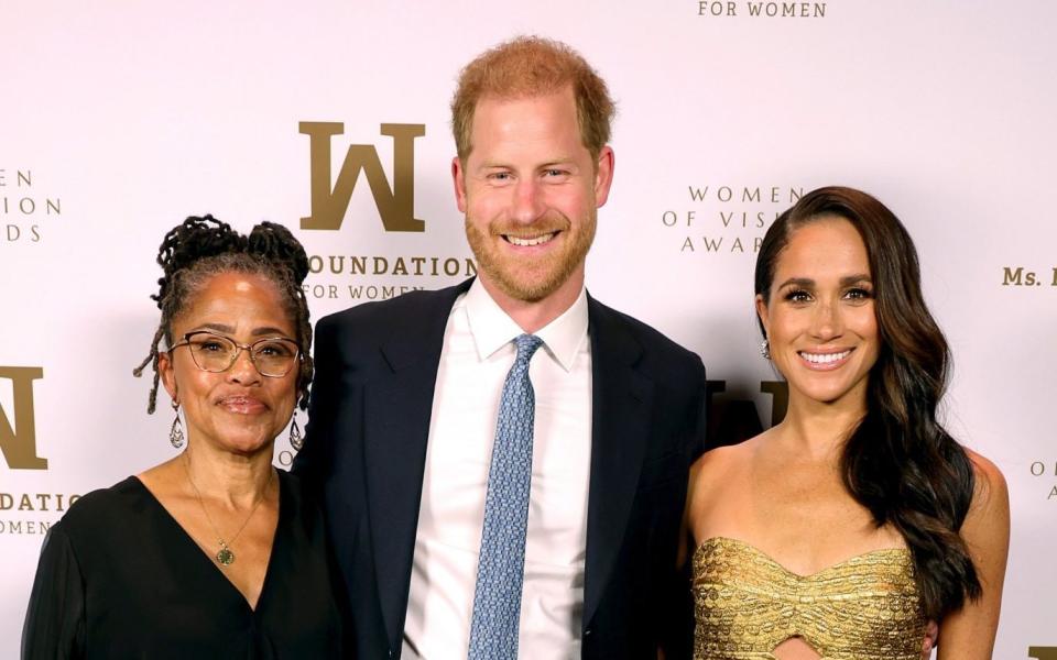 Prince Harry, Meghan and her mother Doria Ragland earlier on Tuesday attending the Women of Vision Awards - Kevin Mazur