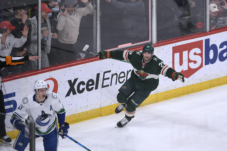 Minnesota Wild left wing Kevin Fiala, right, celebrates his goal as Vancouver Canucks defenseman Tyler Myers skates away during the second period of an NHL hockey game Thursday, April 21, 2022, in St. Paul, Minn. (AP Photo/Craig Lassig)