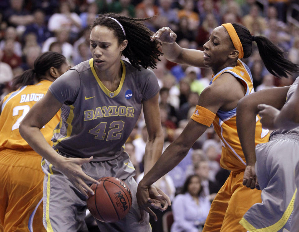 FILE - In this March, 2012, file photo, Baylor's Brittney Griner grabs a rebound in front of Tennessee's Glory Johnson during an NCAA college basketball tournament regional final in Des Moines, Iowa. Griner led Baylor to its first unbeaten season and the school became the first to ever win 40 games. (AP Photo/Charlie Neibergall, File)