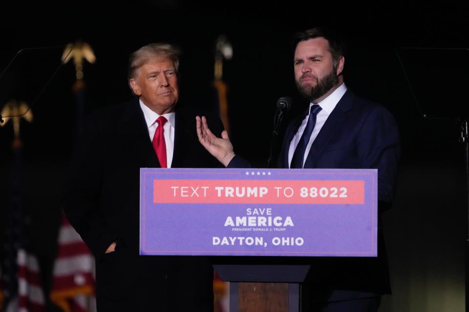 Former President Donald Trump greets U.S. Senate candidate J.D. Vance during a rally at Wright Bros. Aero Inc. at Dayton International Airport on Monday, Nov. 7, 2022, in Vandalia, Ohio.