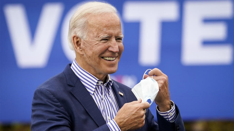 Democratic presidential nominee Joe Biden takes off his face mask to speak during a drive-in campaign rally at Bucks County Community College on October 24, 2020 in Bristol, Pennsylvania. (Drew Angerer/Getty Images)