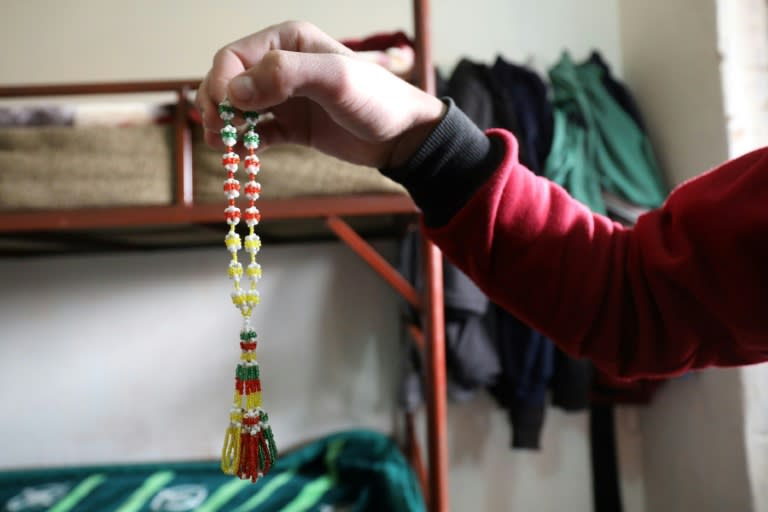 A teenage boy shows prayer beads he made at the Hori rehabilitation centre, on February 11, 2018