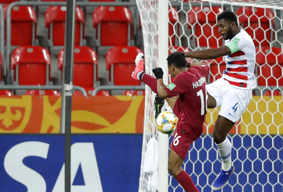 United States' Mark McKenzie, right, tries to block a shot from Qatar's Hashim Ali during the Group D U20 World Cup soccer match between USA and Qatar, in Tychy, Poland, Thursday, May 30, 2019. (AP Photo/Sergei Grits)