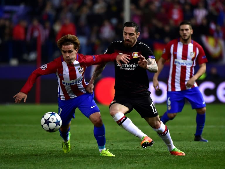 Atletico Madrid's forward Antoine Griezmann vies with Leverkusen's defender Roberto Hilbert (R) during the UEFA Champions League round of 16 second leg football match March 15, 2017