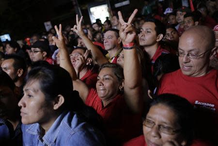 Supporters of Salvador Sanchez Ceren, presidential candidate for the Farabundo Marti Front for National Liberation (FMLN), listen as he speaks after the official presidential elections results in San Salvador February 2, 2014. REUTERS/Henry Romero