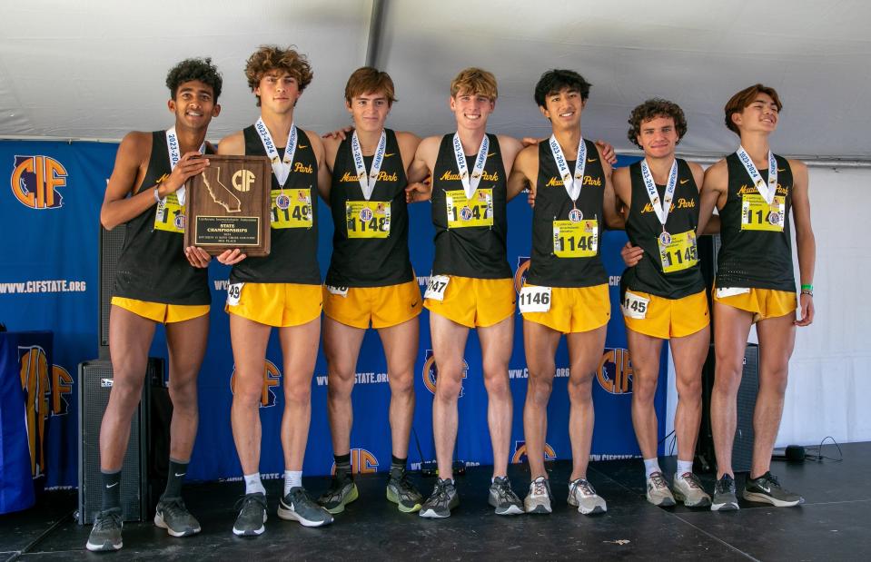 The Newbury Park High boys team pose with the Division II third-place plaque at the CIF State Cross Country Championships on Saturday, Nov. 25, 2023, at Woodward Park in Fresno.