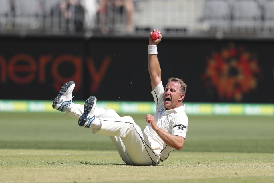 New Zealand's Neil Wagner celebrates after catching Australia's David Warner during play in the first cricket test in Perth, Australia, Thursday, Dec. 12, 2019. (AP Photo/Trevor Collens)