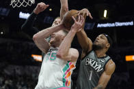 San Antonio Spurs center Jakob Poeltl (25) has his shot blocked by Brooklyn Nets forward Bruce Brown (1) during the second half of an NBA basketball game Friday, Jan. 21, 2022, in San Antonio. (AP Photo/Eric Gay)
