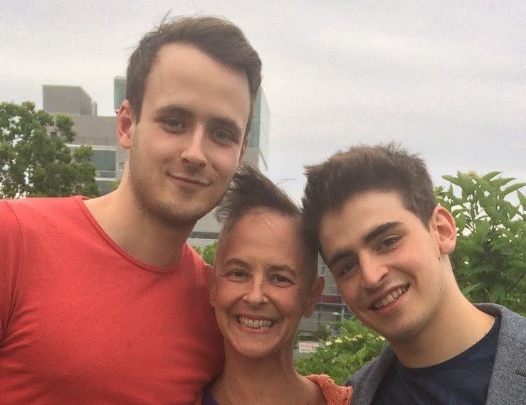 <i>S</i>usan, with her hair mostly out from chemo, and her sons Oliver (left) and Nathan (right) at Nathan's graduation from the National Circus School (background).&nbsp; (Photo: Susan Briscoe)