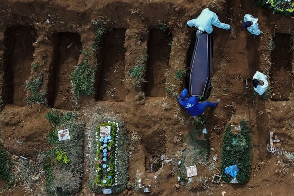 An aerial picture shows grave diggers burying an alleged COVID-19 victim at the Vila Formosa Cemetery, in the outskirts of Sao Paulo, Brazil.