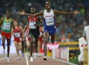 Mo Farah of Britain reacts as he crosses the finish line to win the men's 5000m event during the 15th IAAF World Championships at the National Stadium in Beijing, China August 29, 2015. REUTERS/Lucy Nicholson