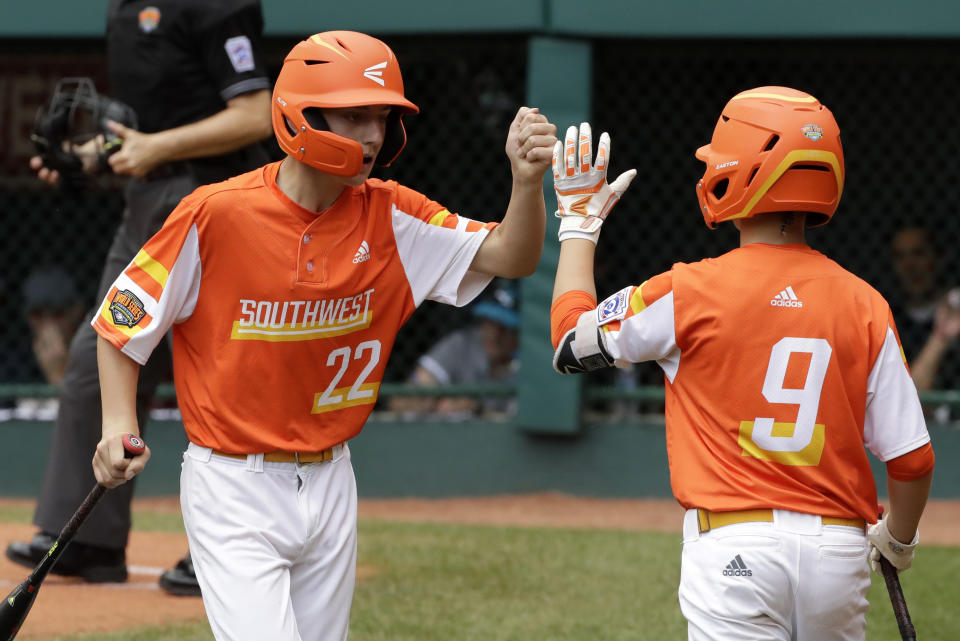 River Ridge, Louisiana's Reece Roussel (22) celebrates with Conner Perrot after scoring on a double by Marshall Louque off Curacao pitcher Keven Rosina during the third inning if the Little League World Series Championship game in South Williamsport, Pa., Sunday, Aug. 25, 2019. (AP Photo/Gene J. Puskar)