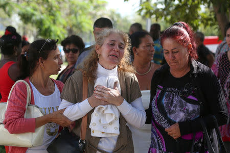 Relatives of victims of the Boeing 737 plane that crashed after taking off from Havana's main airport yesterday, react as they leave the Legal Medical Institute in Havana, Cuba, May 19, 2018. REUTERS/Alexandre Meneghini