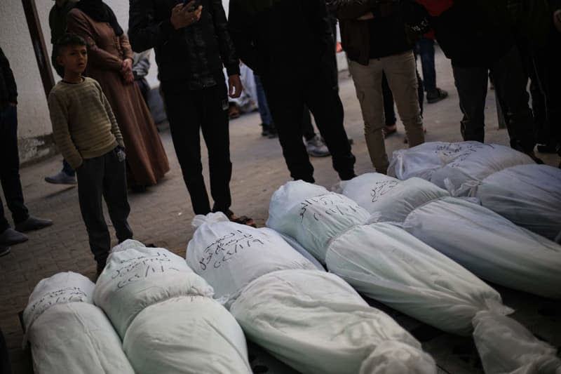 Palestinians mourn next to the bodies of their relatives of the Nofal family, who were killed following Israeli air strikes on a building west of the city of Rafah, killing at least 15 people. Mohammed Talatene/dpa